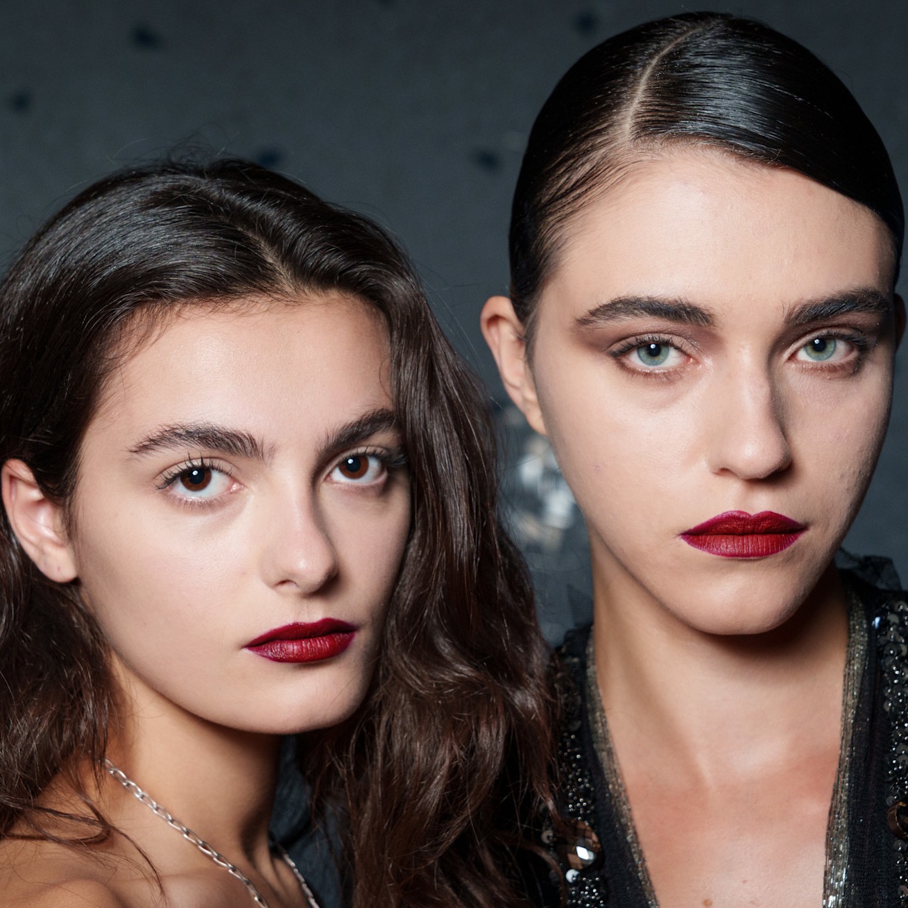two runway models with red lipstick