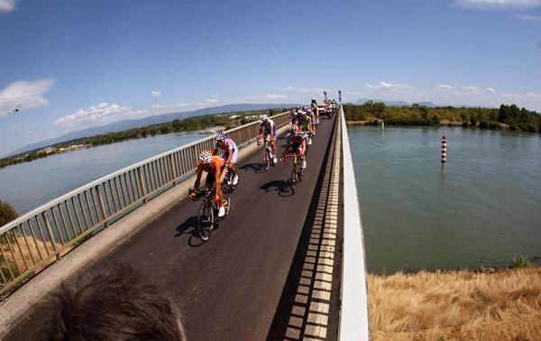 Riders in the day's major break cross a bridge on their way to Aubenas.