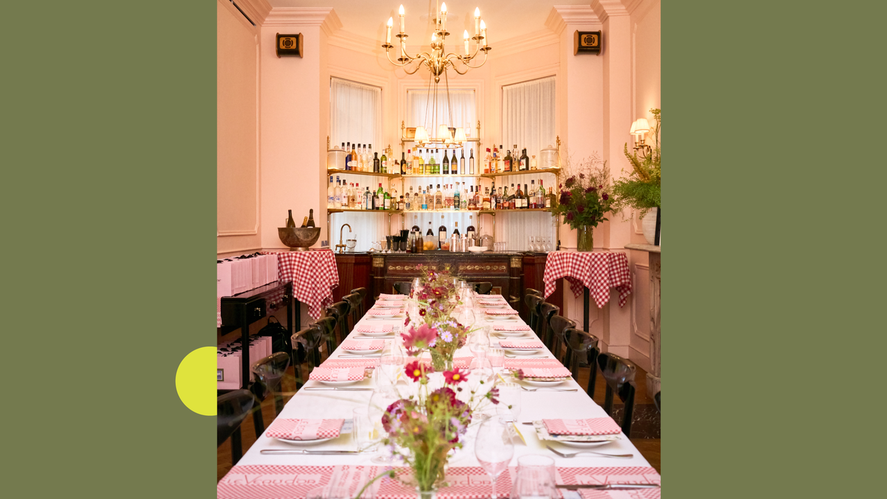 A pink dining room with a table laid with pretty flowers
