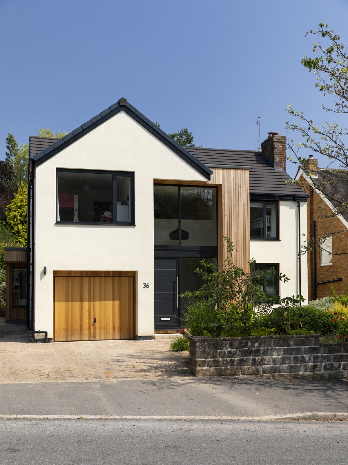 The front elevation has a glazed double-storey atrium brings light into the centre of the home