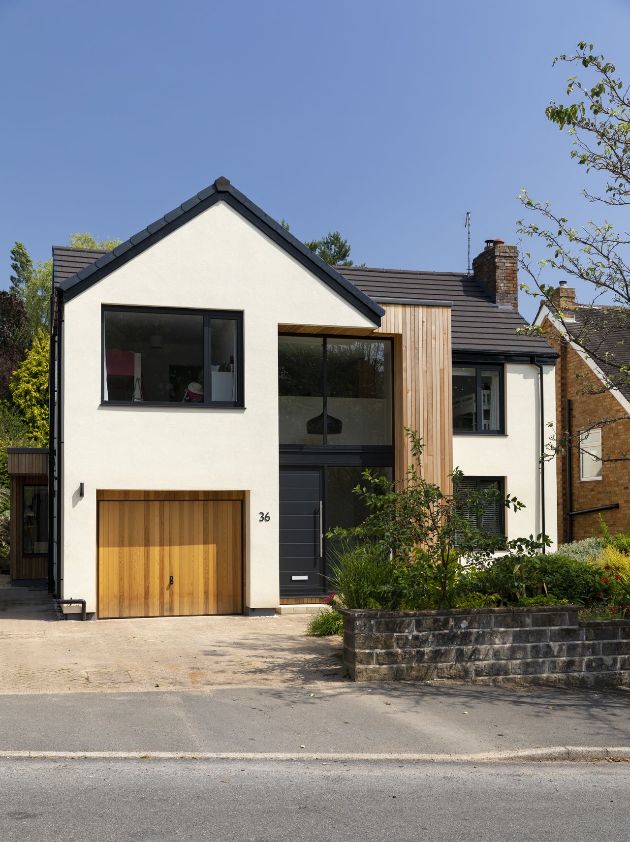 The front elevation has a glazed double-storey atrium brings light into the centre of the home