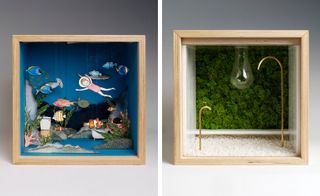 Two side-by-side photos of artistic interpretations of a dolls’ house in square, wooden boxes by several London-based design studios. The first box features a bathroom with a blue floor and walls, a toilet, a bath, a girl and various types of fish suspended from the ceiling, seaweed and coral. And the second box features greenery on the back wall, small white stones on the floor, a light bulb and two pale gold, curved pipes in different sizes