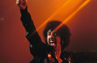 Phil Lynott onstage, raising his fist