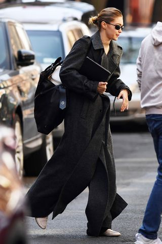 Gigi Hadid wearing a coat and cream loafers in NYC