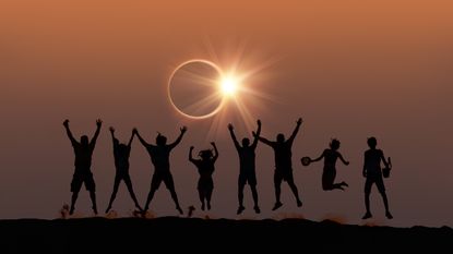 Total Solar Eclipse showing people wearing glasses and looking at the eclipse