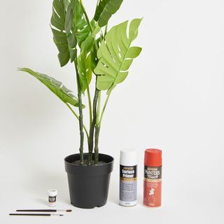 artificial plant pot with paint brush and spray paint and surface primer