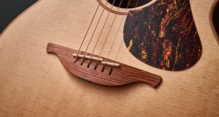 The bridge of the Lowden F-12 Spruce Top acoustic guitar