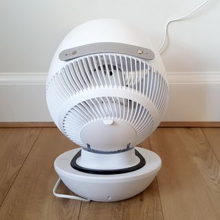 A back view of the white MeacoFan 1056 Air Circulator on a wooden floor
