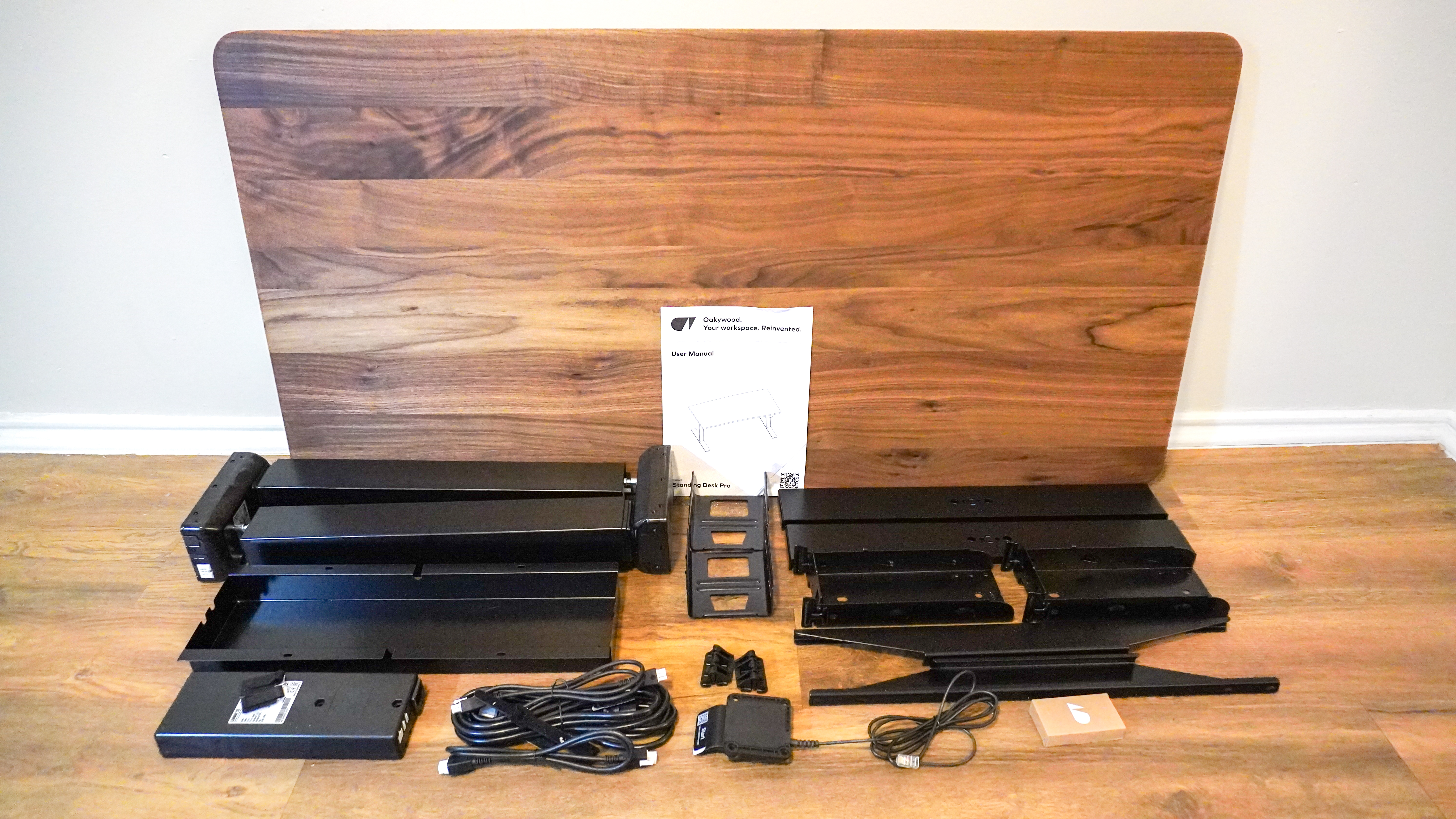 The Oakywood Standing Desk Pro unboxed with all the pieces laid out on the floor