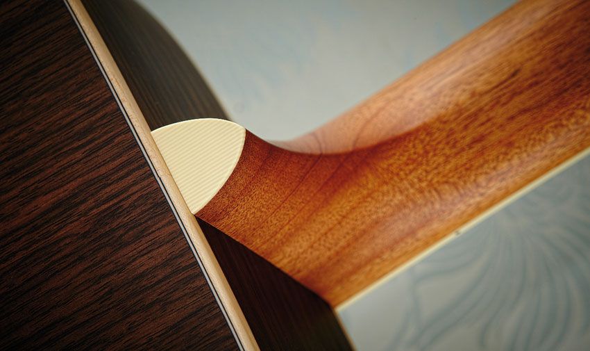The mahogany neck contrasts the even stripes of the rosewood back and sides. All woods are solid, of course