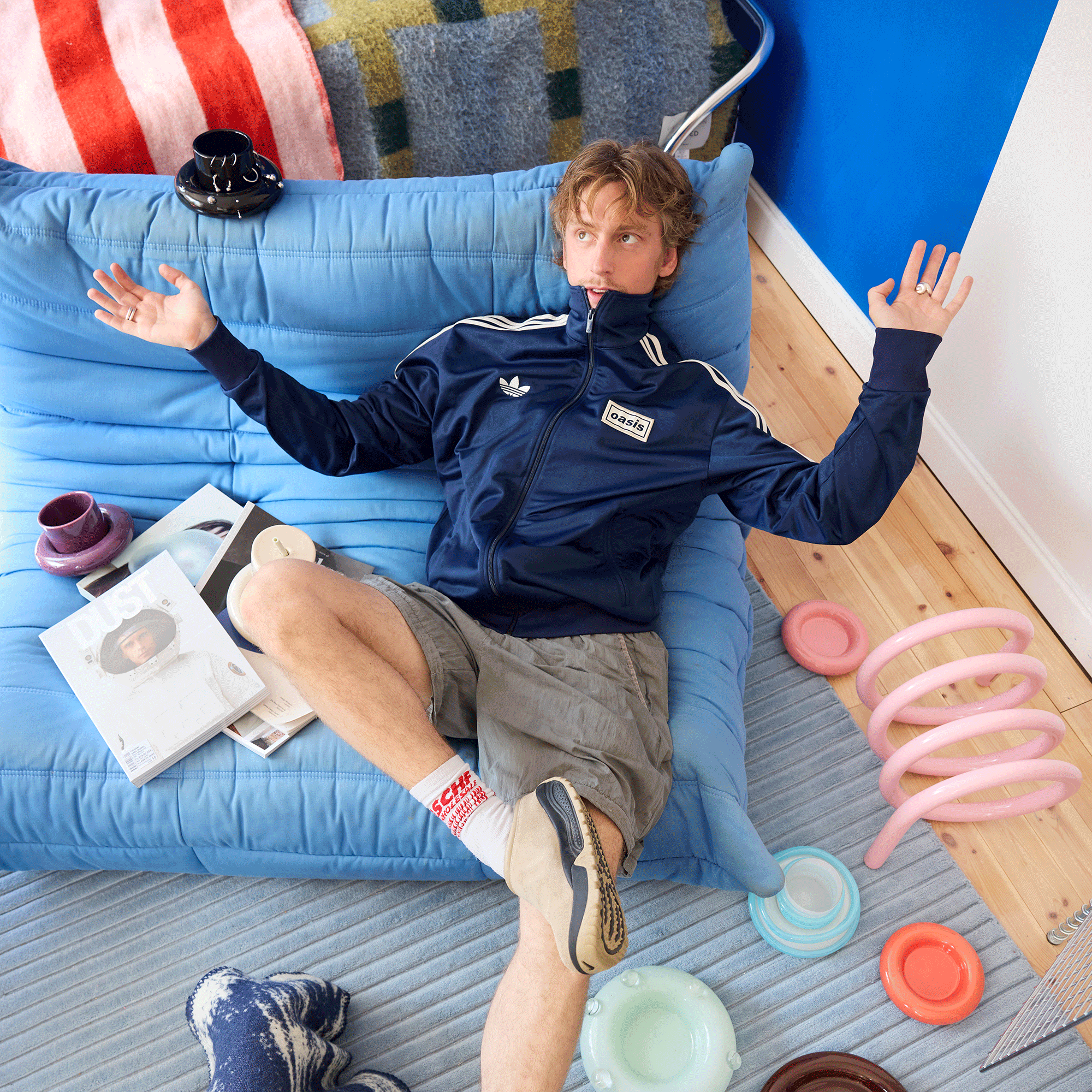 Gustaf Westman studio apartment blue walls with mirror decor and togo settee
