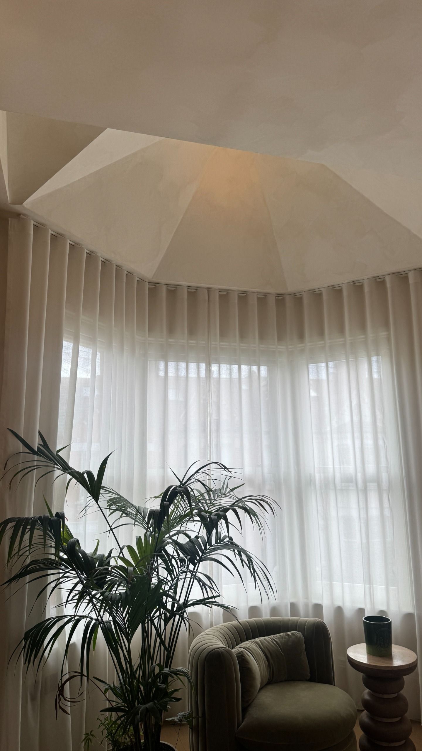 a faceted roof above a bay window