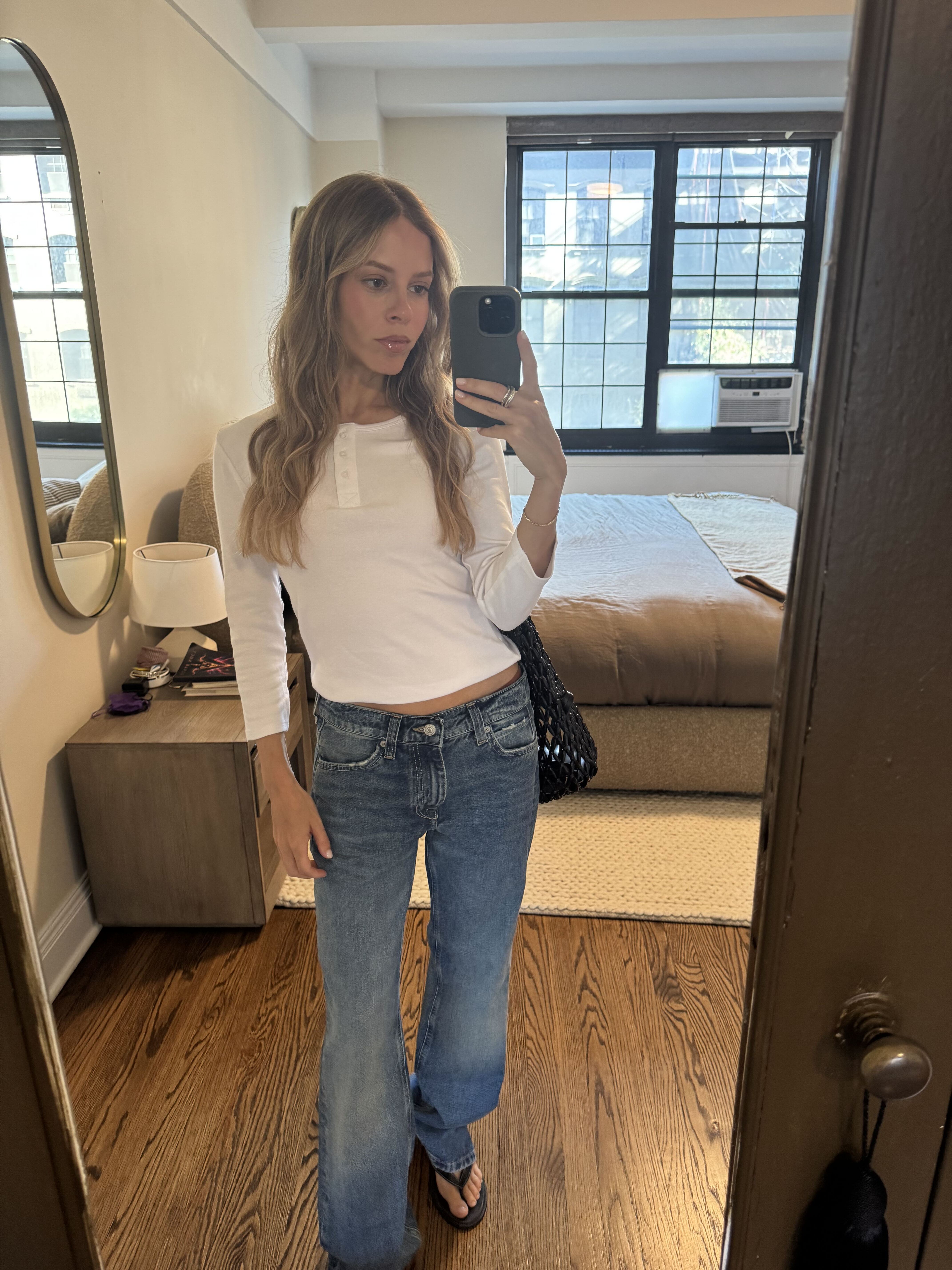 nikki wears the white zara henley t-shirt, low-rise jeans, flip-flops and a beaded bag.