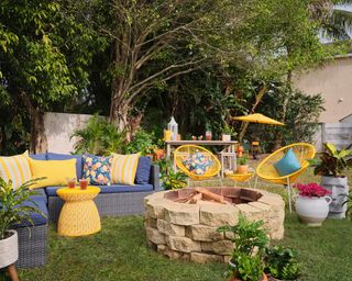 Garden with grey sofa and yellow cushions
