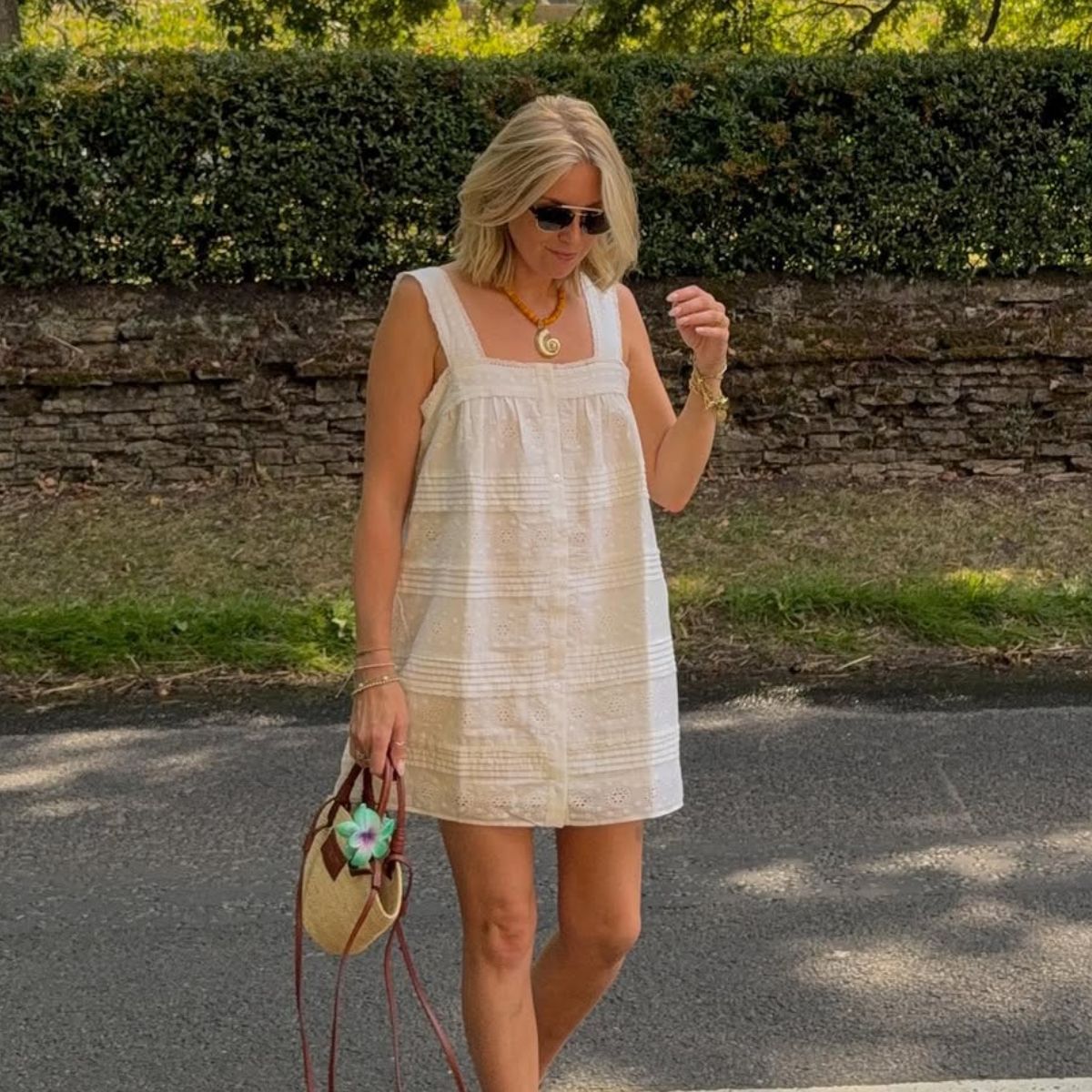 Woman wears white dress, basket bag