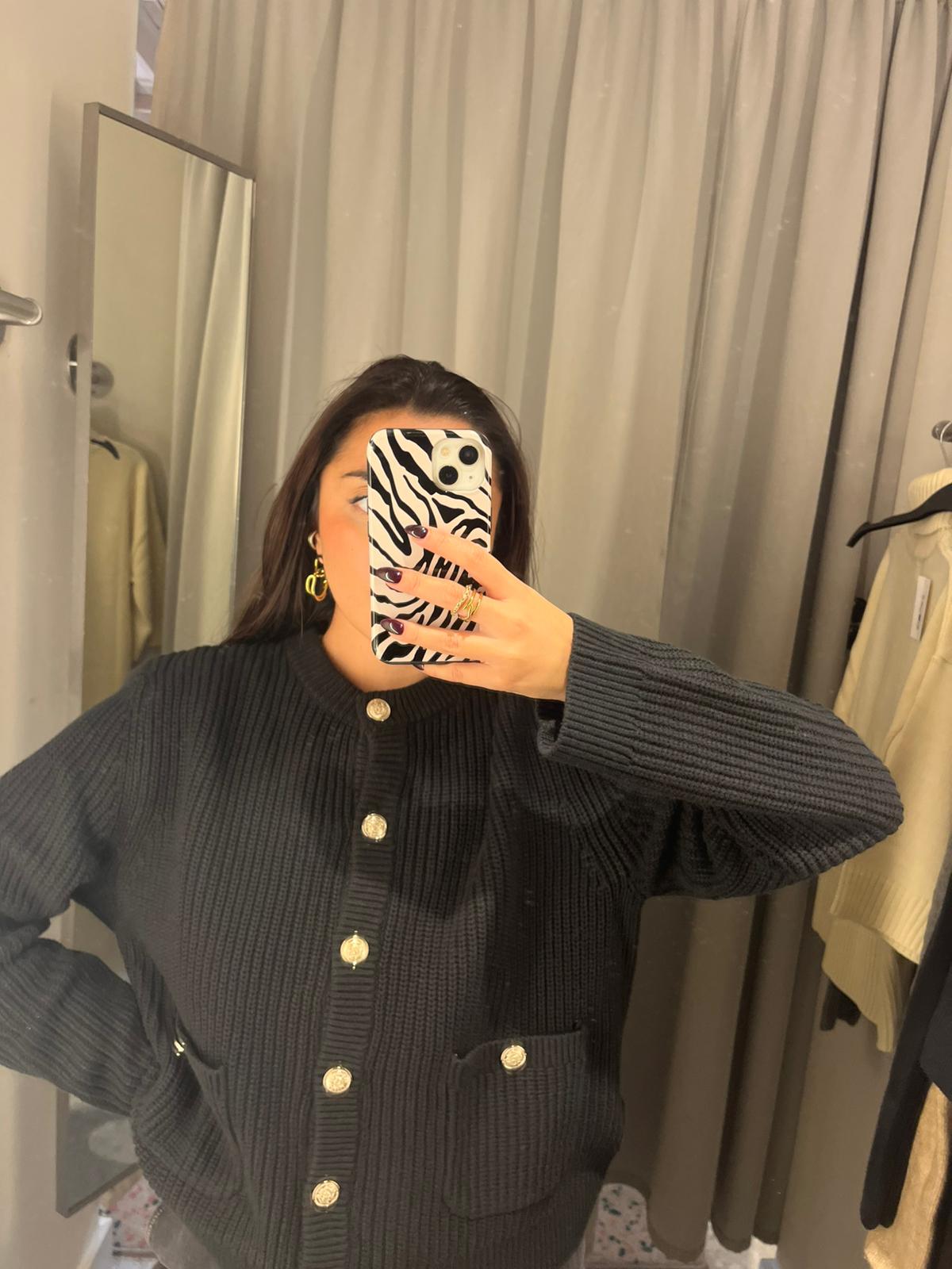 Shopping editor Marina wearing black cardigan with gold buttons