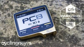 SRM PC8 cycling computer resting on a stone surface