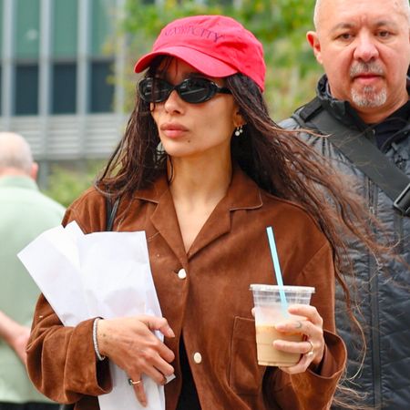 Zoe Kravitz wears a suede jacket with hot pants and ballet flats
