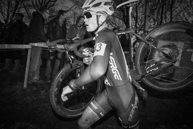 Peter Goguen shoulders the bike to take on one of the many mud sections at Diegem.