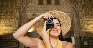 Canon EOS R10 being held by a woman