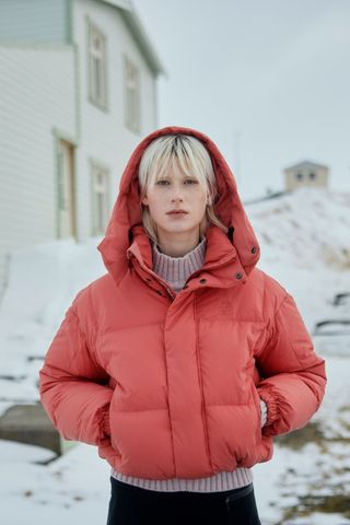 cold weather clothing - woman wearing bright short puffer jacket