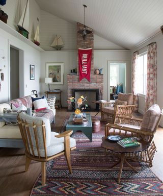 living room with sloping roof and with model boats on high shelf and blue wooden couch