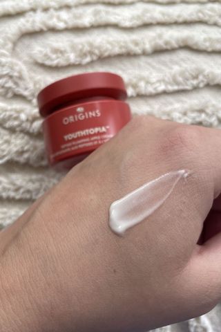 Valeza showing the consistency of the apple peptide cream from the Origins Youthtopia range on the back of her hand