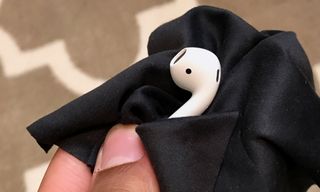 Cleaning AirPods with a microfiber cloth