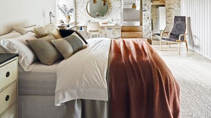 bedroom with double bed layered with sheets and pillows