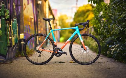 The Trek Emonda ALR 5 Road Bike in blue and orange
