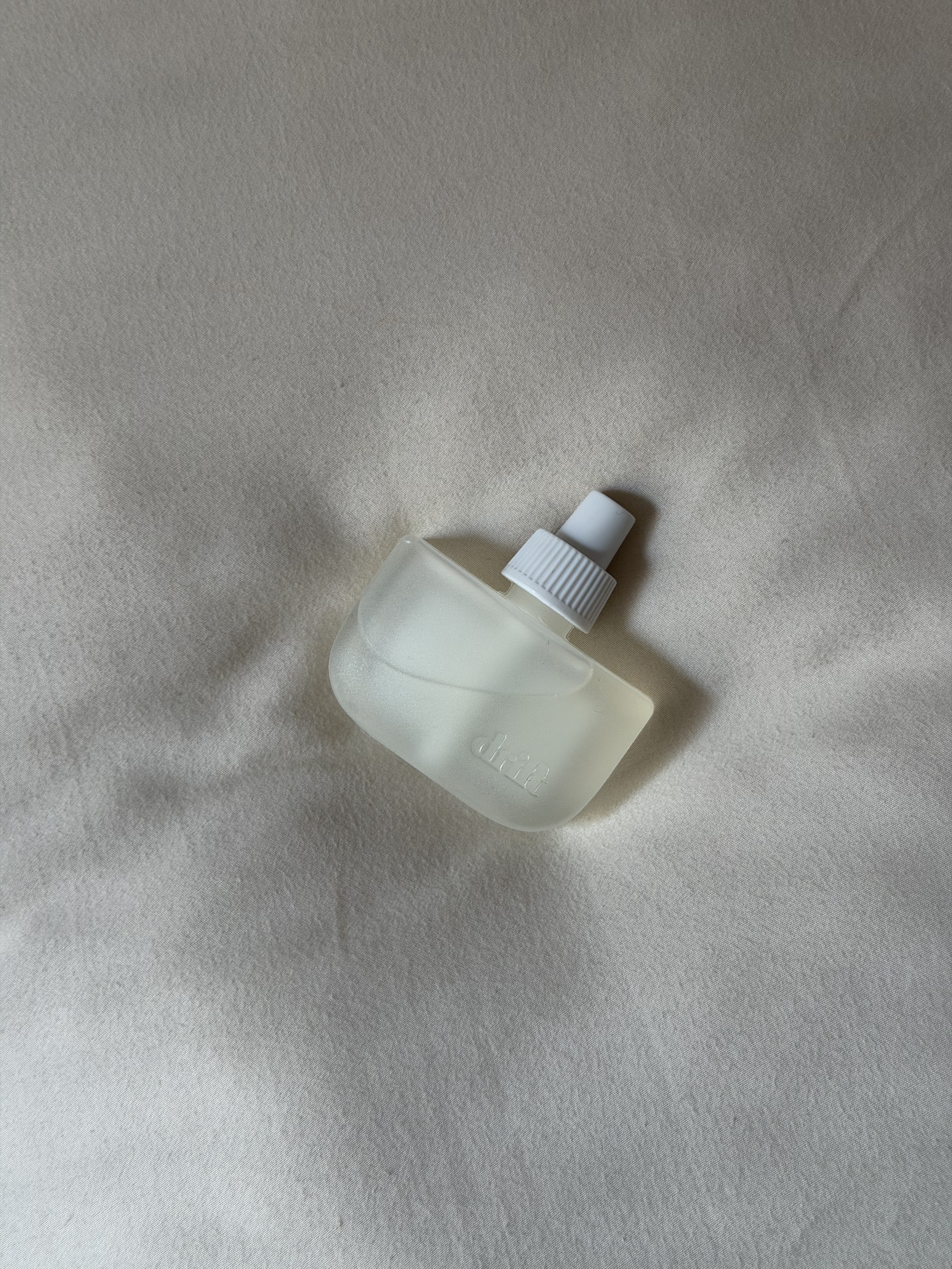The Drift Home Scent Diffuser in Rest &amp; Relax on a bed.
