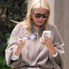 Actress Gwyneth Paltrow attending Jennifer Meyer's baby shower in Los Angeles wearing a belted cardigan, vintage jeans, and kitten-heel sandals.