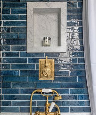 Marble niche in bathroom with blue tiles around it
