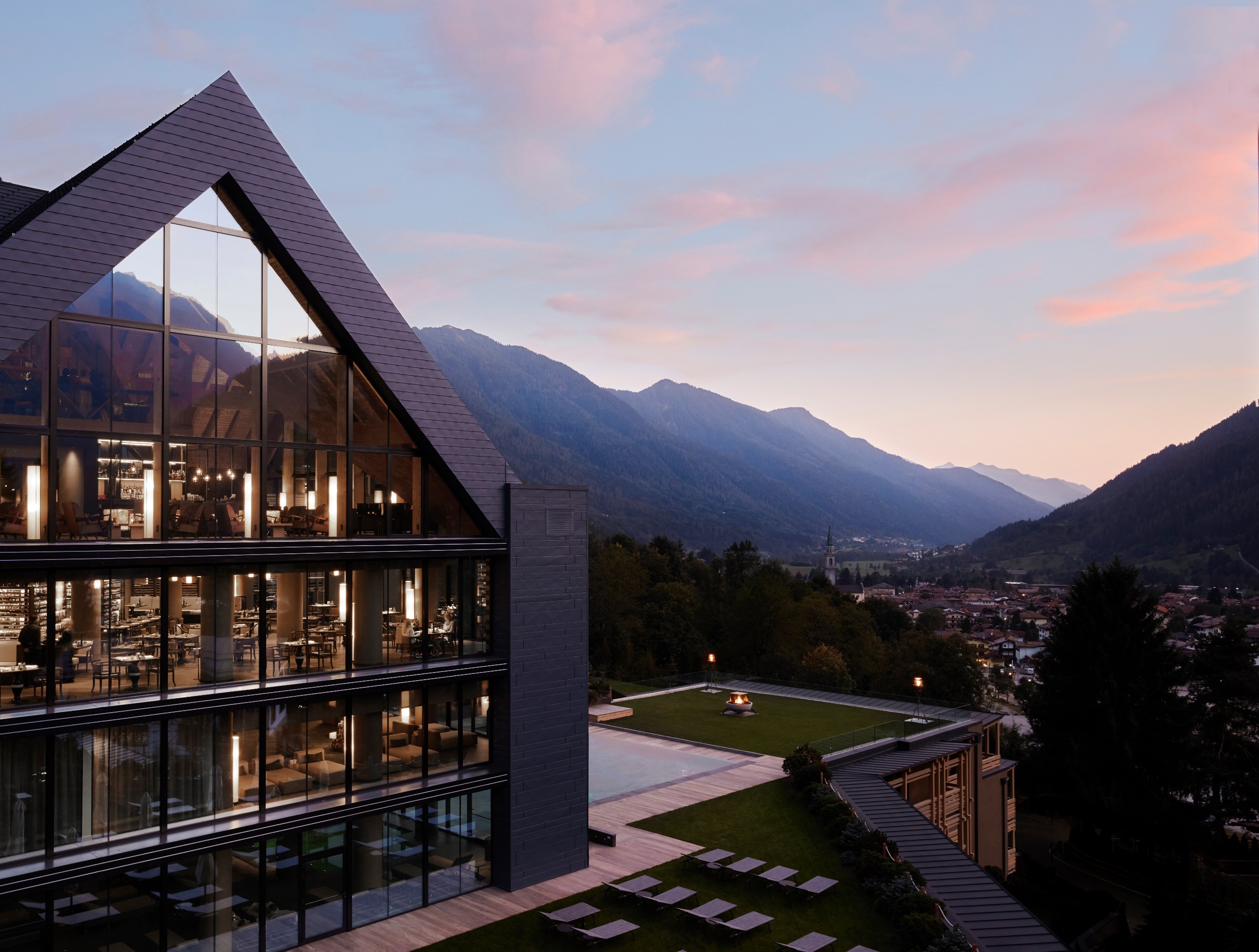 Hotel exterior of LEFAY Resort &amp; Spa in the Dolomites, overlooking the mountains