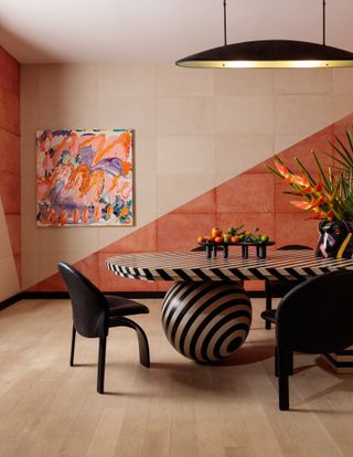 Dining room in pink and terracotta with dark striped table