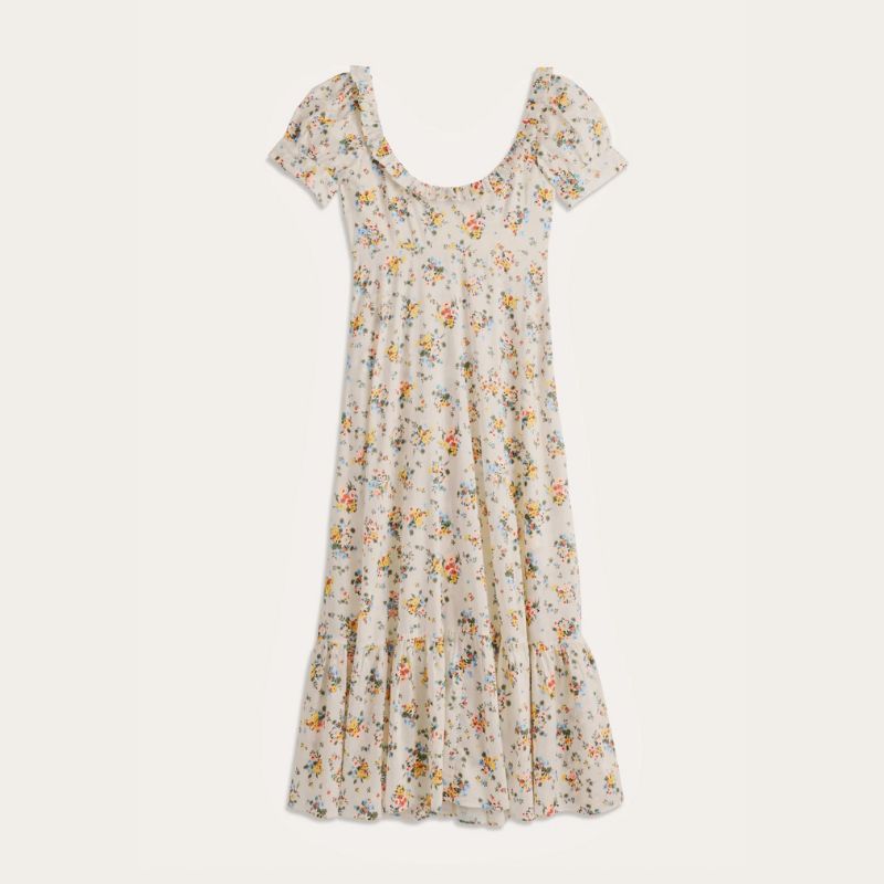 A cutout of a RIXO Sorana Midi floral Dress against a cream background