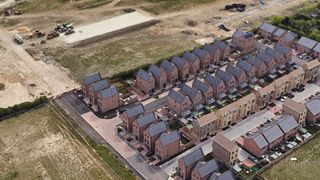 Overhead view of the development shows new builds next to an empty plot of land