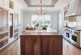 a white and natural wooden finish kitchen