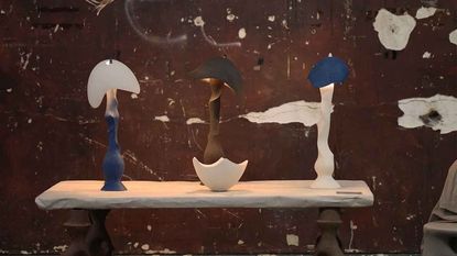 Three lights on a table, made of ceramic with curvaceous, organic forms