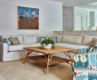 family living room cream sectional and view to kitchen