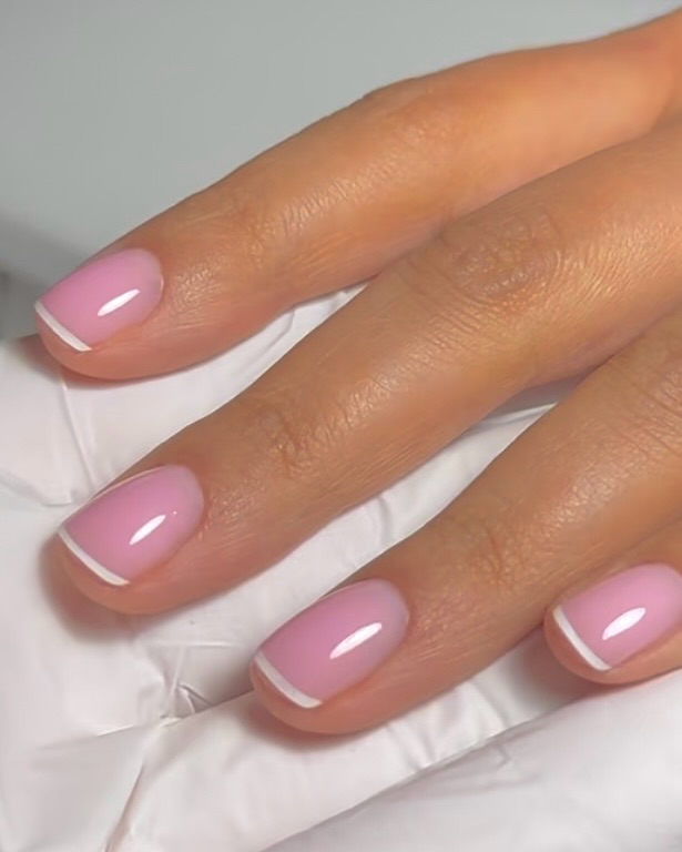 Short squoval nails with sheer pink base and white French tips