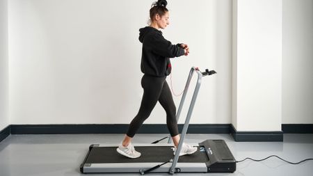 Our reviewer testing the Bluefin Fitness Task 2.0 treadmill