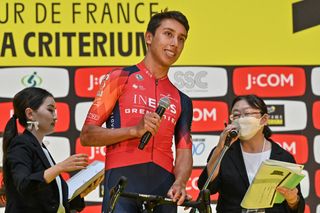 Egan Bernal of Colombia speaks to the crowd during an event a day ahead of the 2023 Tour de France Saitama Criterium