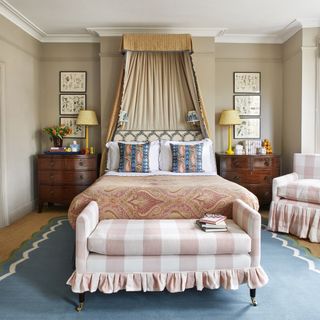 Traditional bedroom by SalvesenGraham with pink check armchair and ottoman