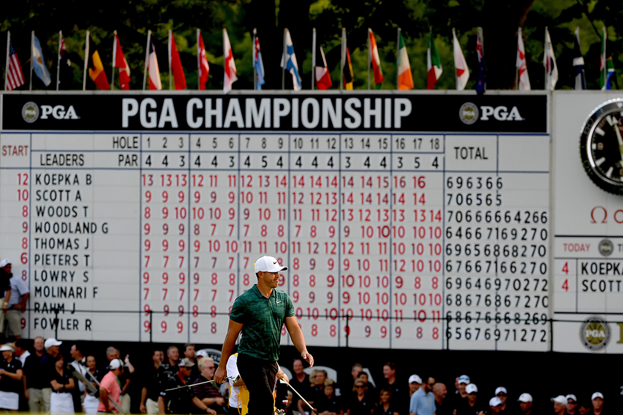 Brooks Koepka in front of a giant scoreboard when leading the PGA Championship at Bethpage Black in 2018