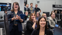Mission team members are excited during Artemis II. 