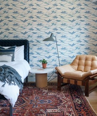 vintage bedroom with blue and white wallpapered accent wall