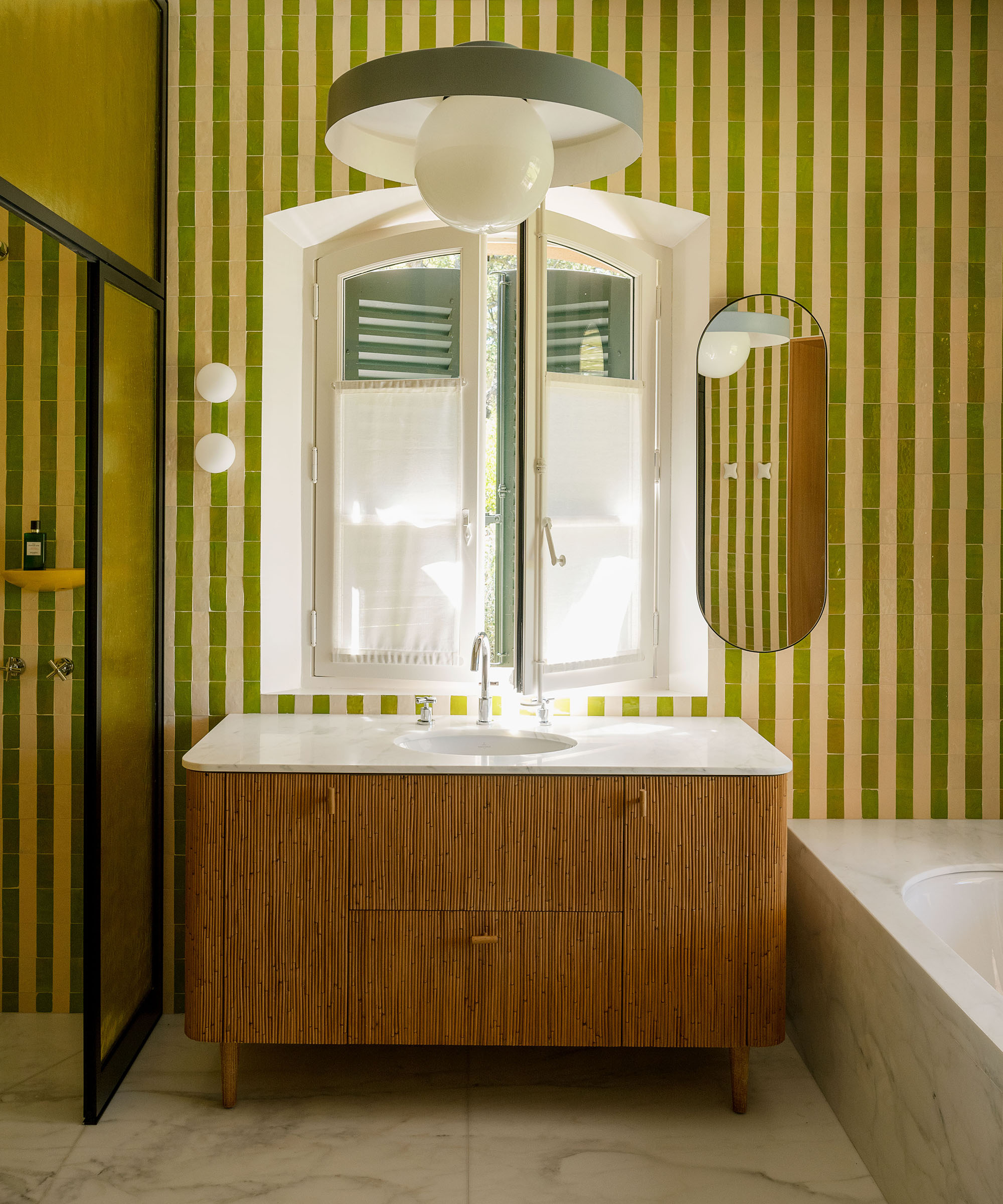 bathroom with striped tiles and wood vanity