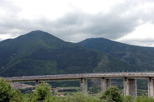 The peloton crosses a bridge en route to the finish of stage 18 in Benevento.