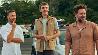 James, Francis and Thomas look at something on a racetrack